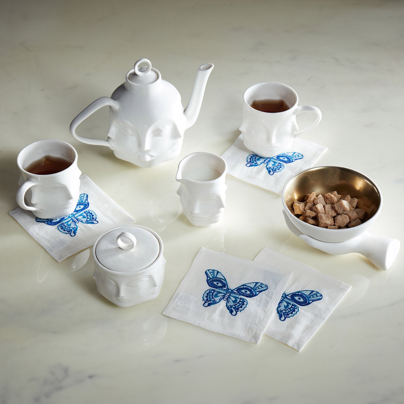dora maar muse teapot blue background - styled view