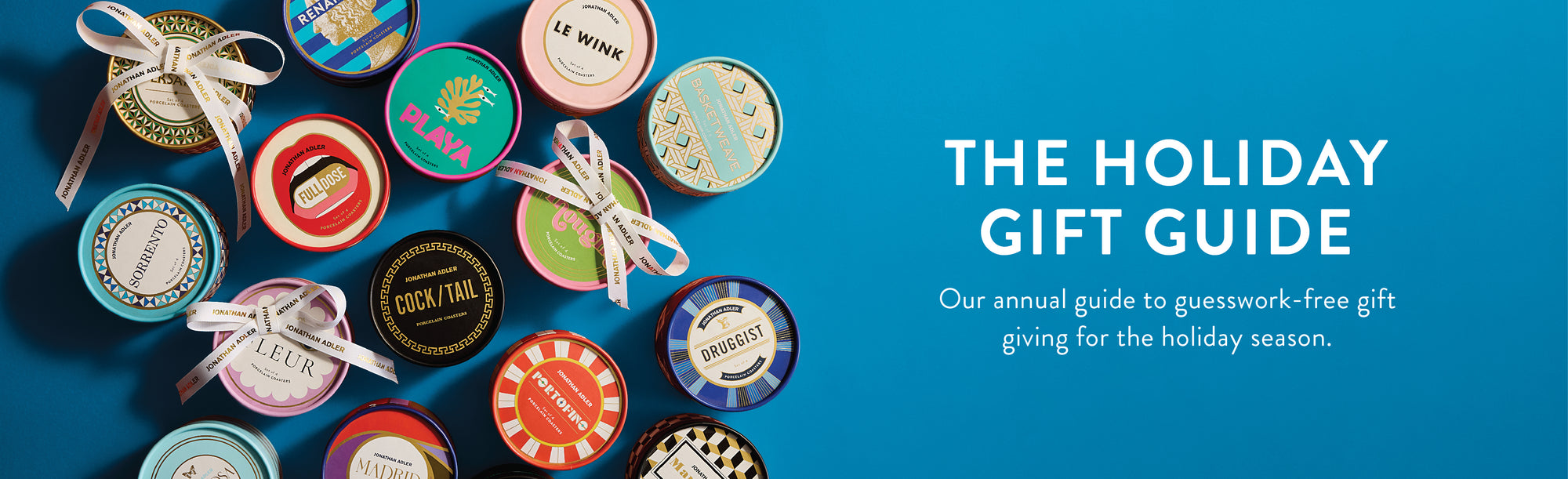 Decorative gift boxes with ribbons on a blue background, featuring 'The Holiday Gift Guide' text.