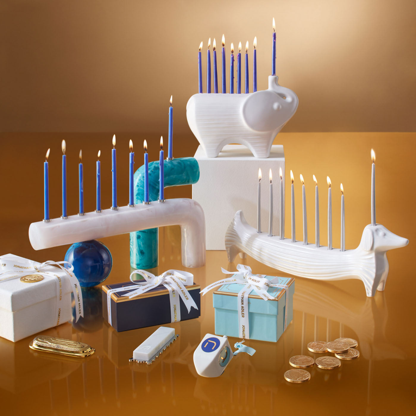 ceramic elephant and dachshund menorahs with candles - styled view 2