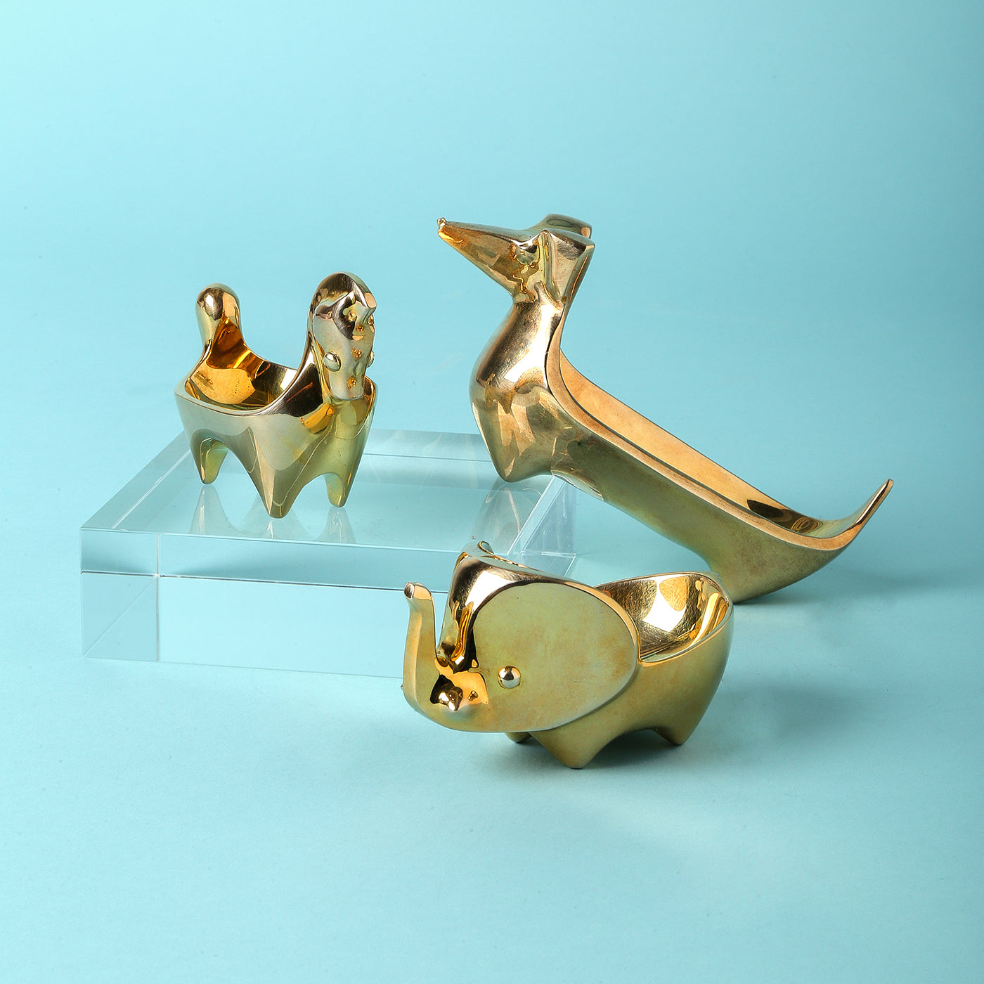 brass ring bowl collection blue background - styled view