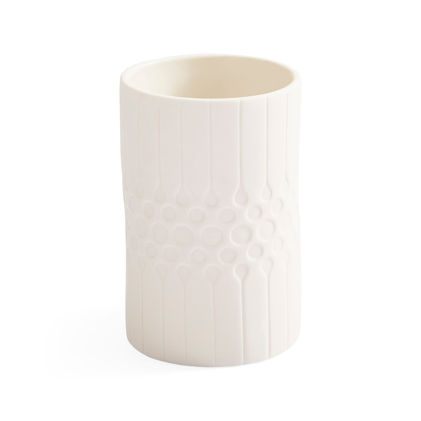 A white ceramic cup with a textured vertical ribbed pattern and a central honeycomb-like circular design, shown on a plain white background.