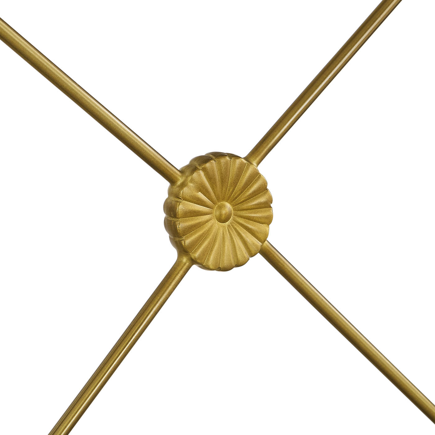 Decorative gold metal design with a central circular element on a white background