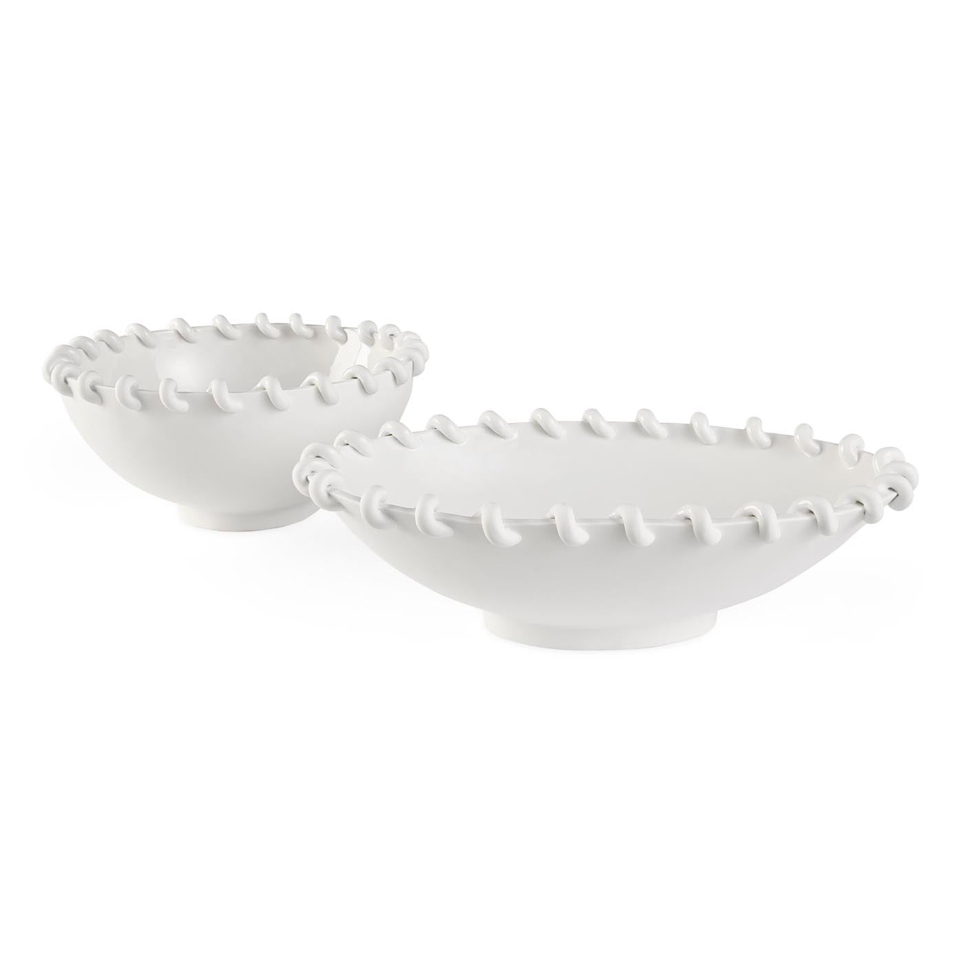 Two white ceramic bowls with textured rim on a white background