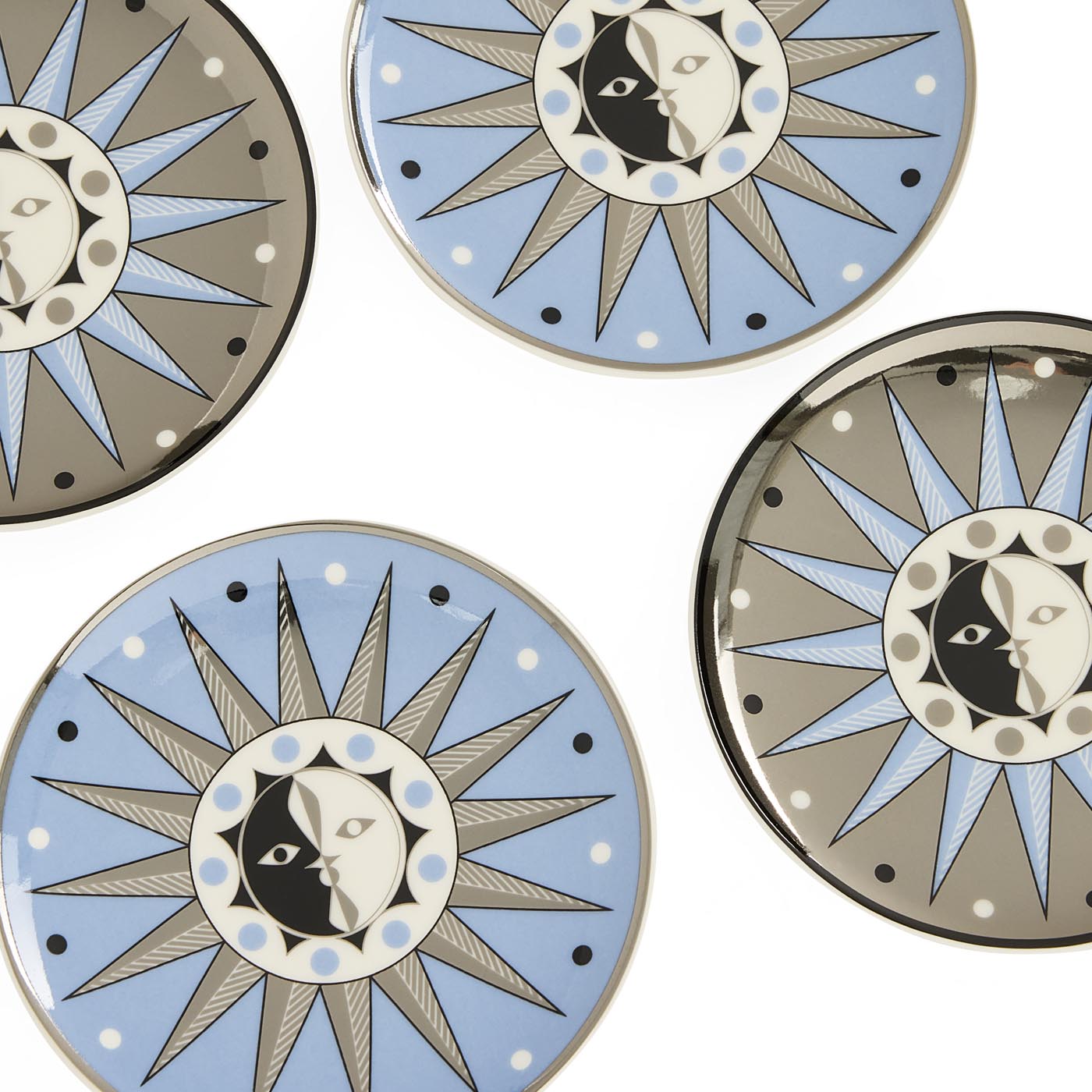 Decorative plates with sun and moon designs on a white background