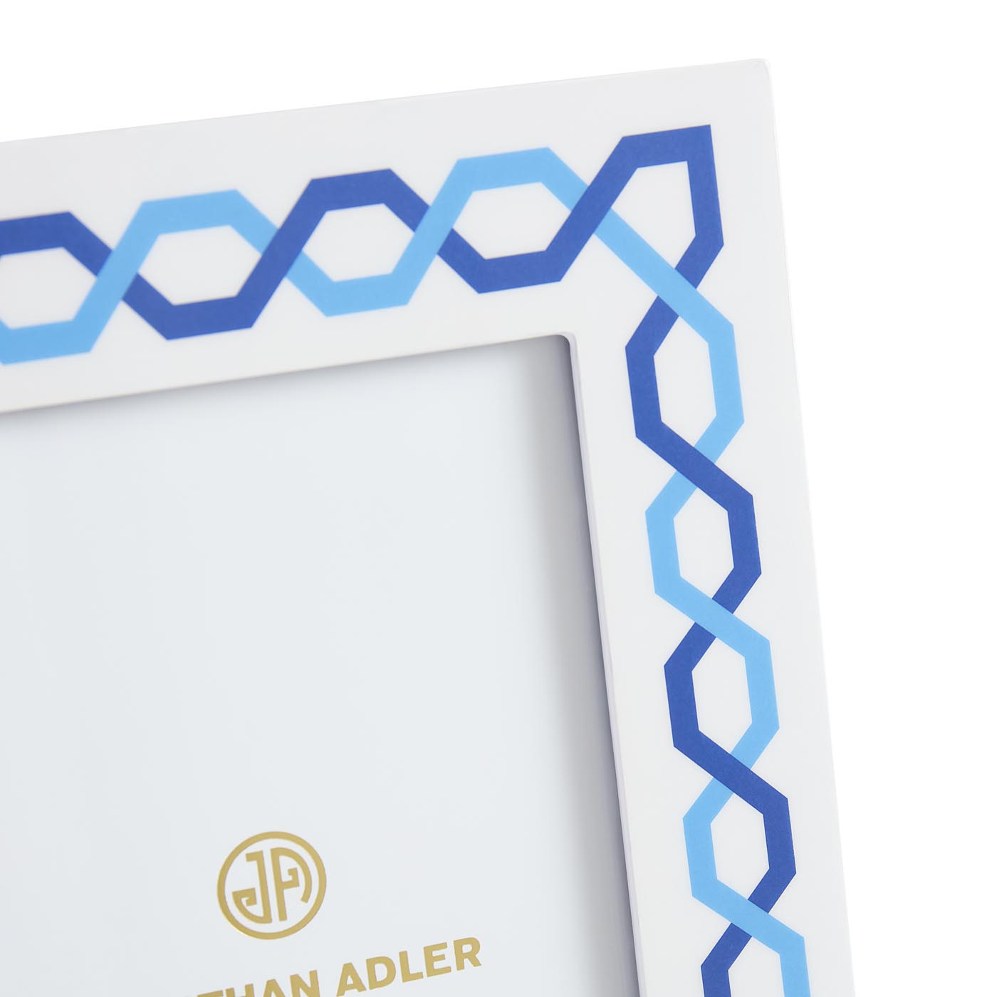 Framed artwork with blue geometric pattern and 'Johan Adler' logo.