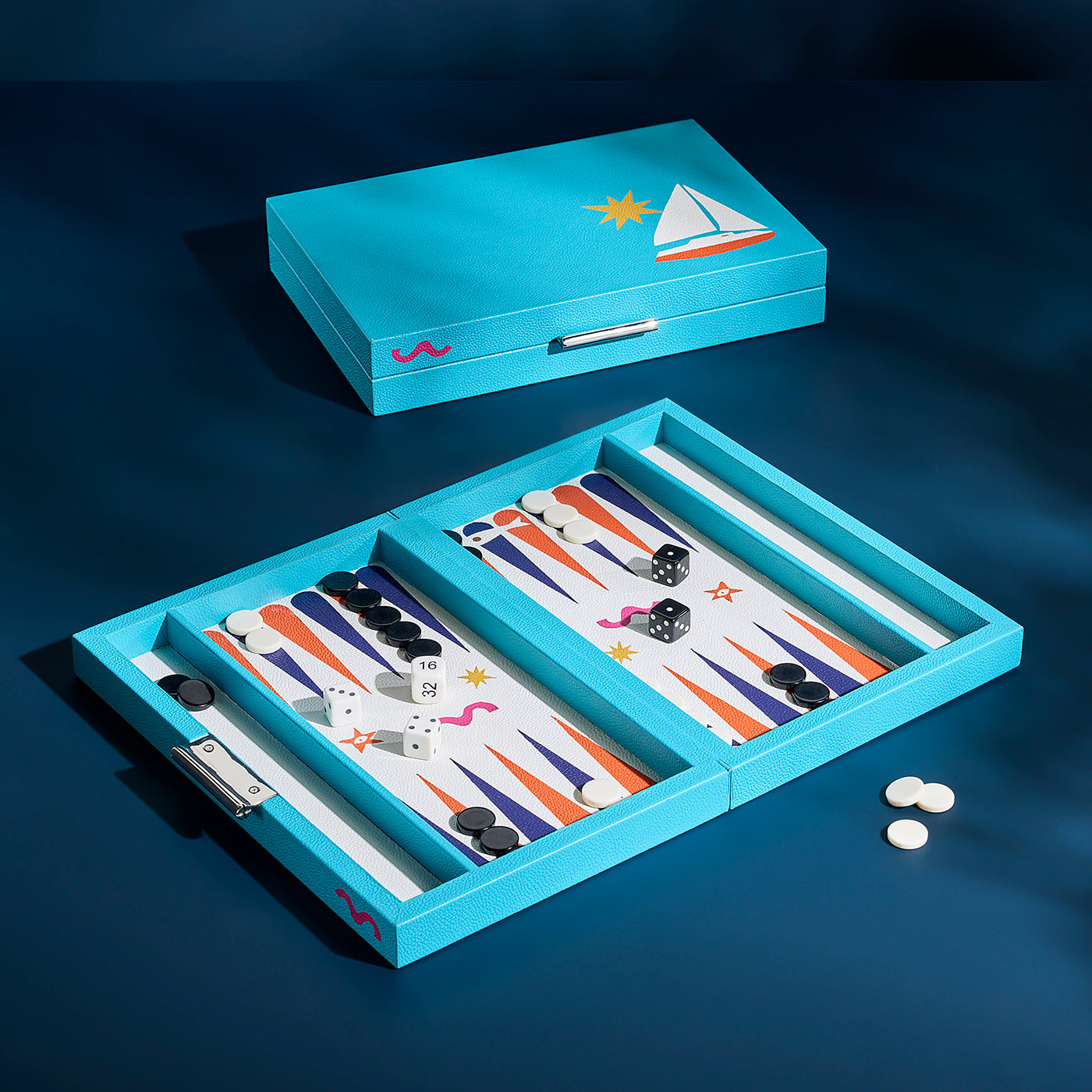 A light blue backgammon set shown open and closed on a dark navy background. The open game board has colorful striped double-ended points, white and black checkers, dice, and a few loose checkers on the table.