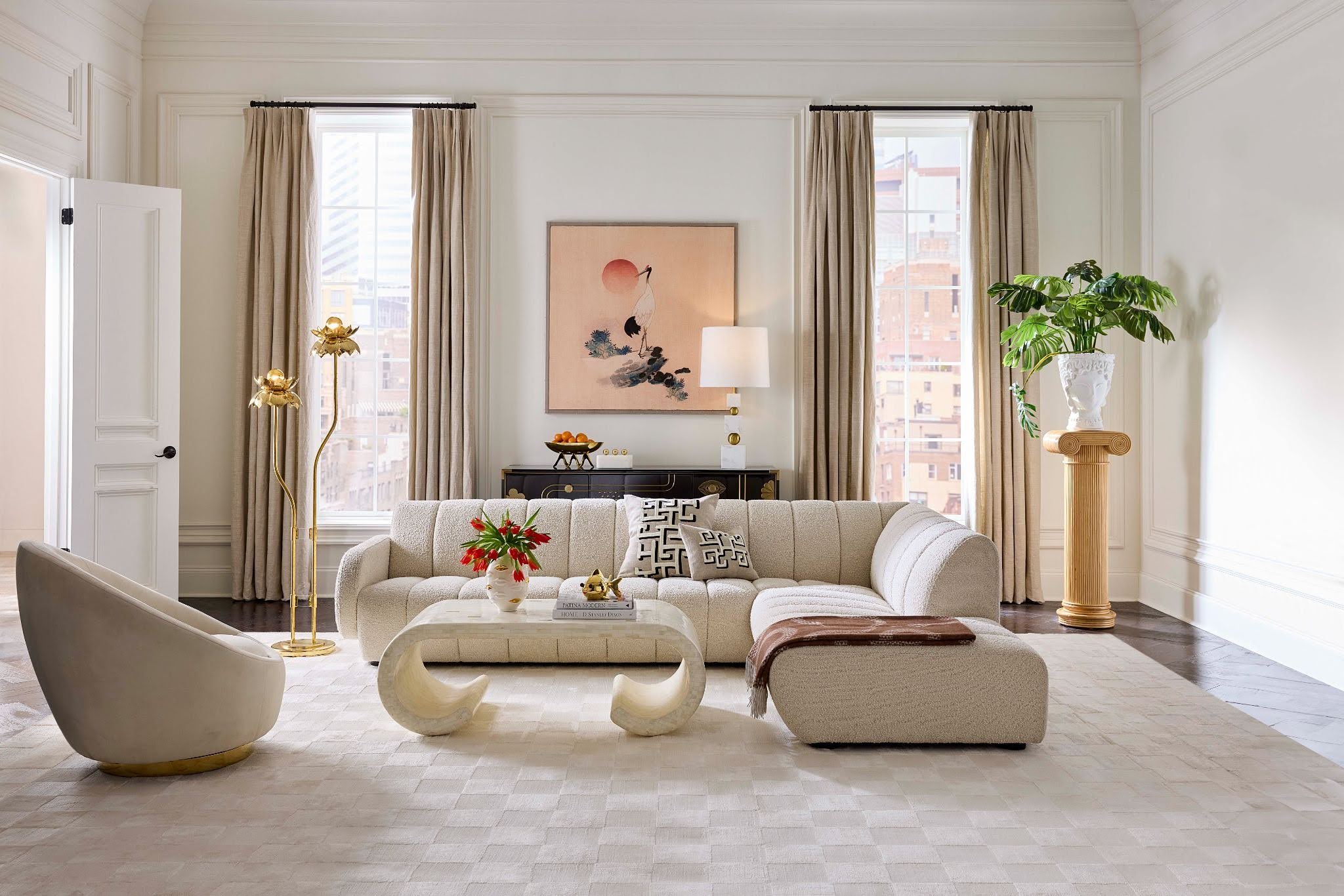 Modern living room with beige sofa, decorative pillows, and a stylish rug.