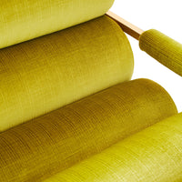 Close-up of a green upholstered chair with a textured fabric.