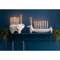 ceramic elephant and dachshund menorahs with candles - styled view