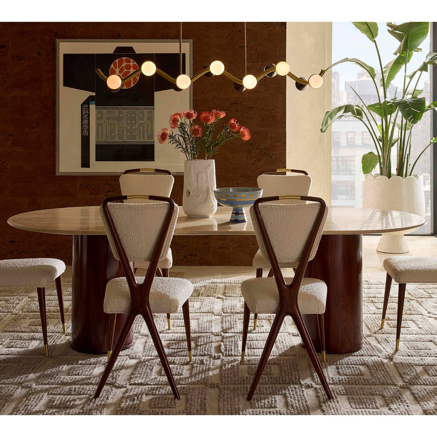 Dining room with a round wooden table, chairs, and decorative elements.
