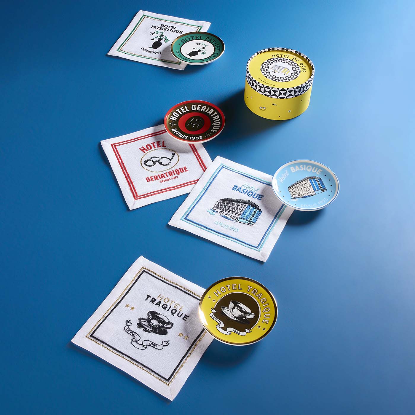 Collection of themed coasters and tins on a blue background