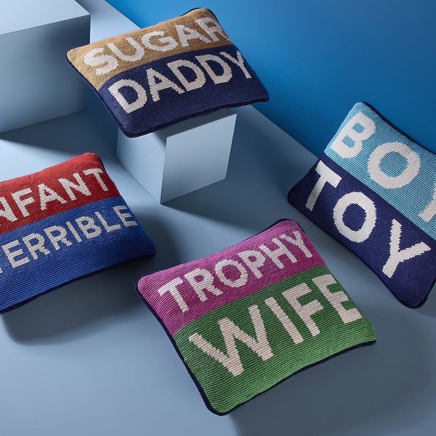 Four colorful pillows with text on a blue background