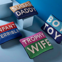 Four colorful pillows with text on a blue background
