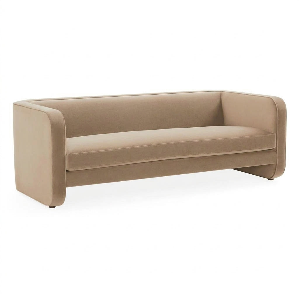 A modern low-profile sofa upholstered in a warm taupe-beige fabric, shown from a three-quarters angle against a plain white background.