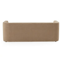 A low-profile rectangular sofa or bench upholstered in a warm taupe fabric, shown from the back against a plain white background.