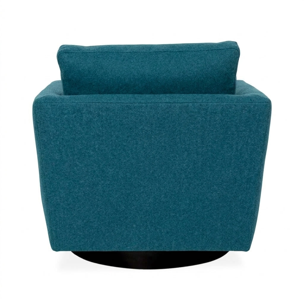 A modern square armchair upholstered in textured teal fabric, featuring a high backrest and a black circular swivel base, shown from the rear against a white background.