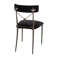 Decorative chair with black cushioned seat and backrest on a white background