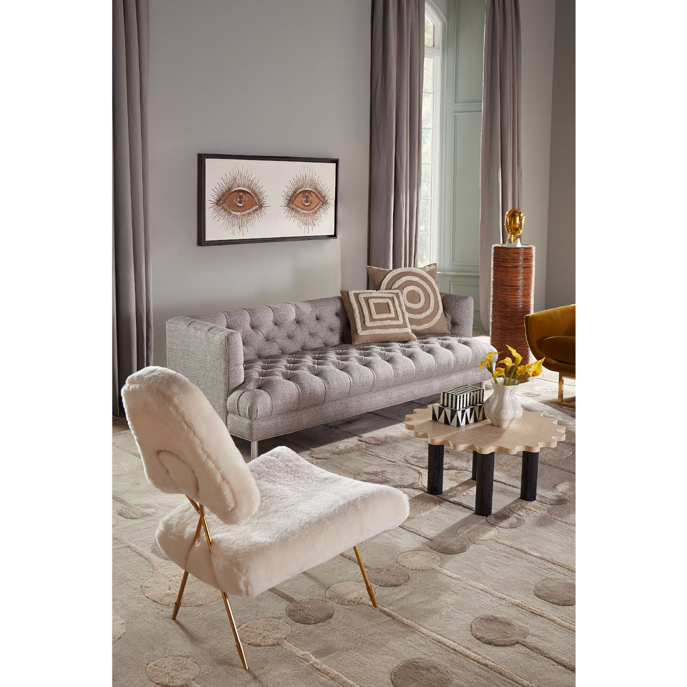 riviera pedestal baxter t-arm sofa ripple round travertine cocktail table - styled view