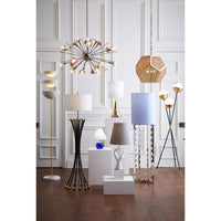 Collection of modern lamps and lighting fixtures in a room with white paneled walls.