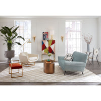 Modern living room with a blue sofa, white armchair, and colorful abstract art on the wall.