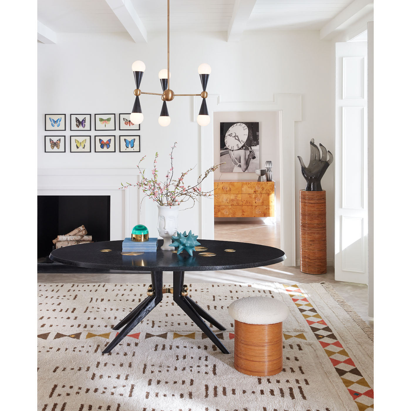 riviera pedestal trocadero dining table riviera tuffet caracas six-light chandelier - styled view