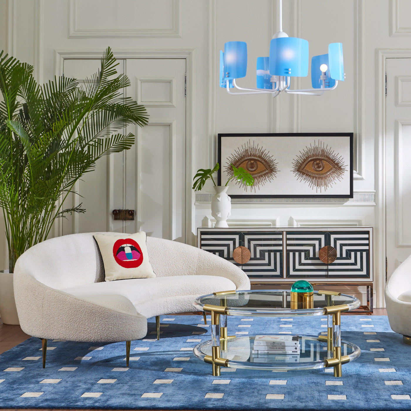 ether curved sofa olympus oatmeal riviera cocktail table baxter t-arm chair with bullion fringe - styled view
