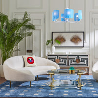 ether curved sofa olympus oatmeal riviera cocktail table baxter t-arm chair with bullion fringe - styled view