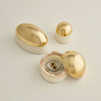 Set of gold and silver jewelry boxes on a light background