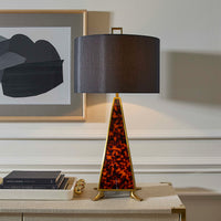 Decorative table lamp with a leopard print base on a side table.