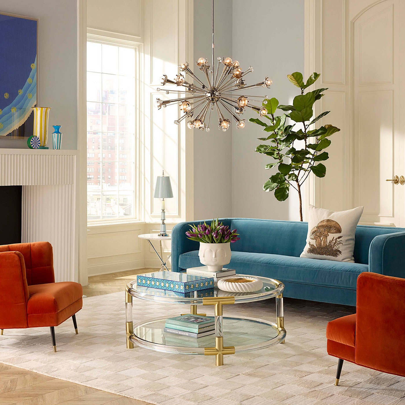 Modern living room with blue sofa, orange armchair, and decorative elements.