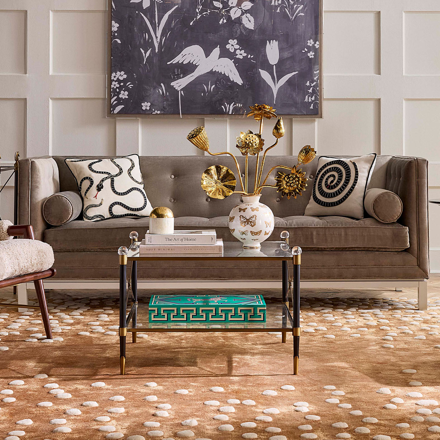 Living room with a gray sofa, decorative pillows, a coffee table, and wall art.