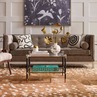 Living room with a gray sofa, decorative pillows, a coffee table, and wall art.