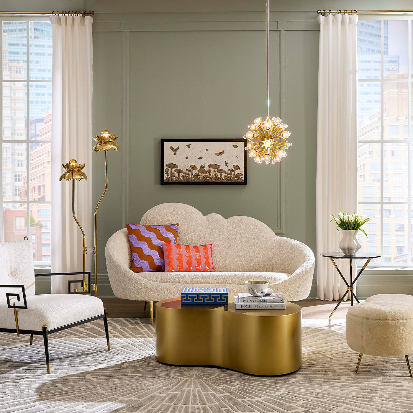 Modern living room with a gold coffee table, white sofa, and decorative pillows.