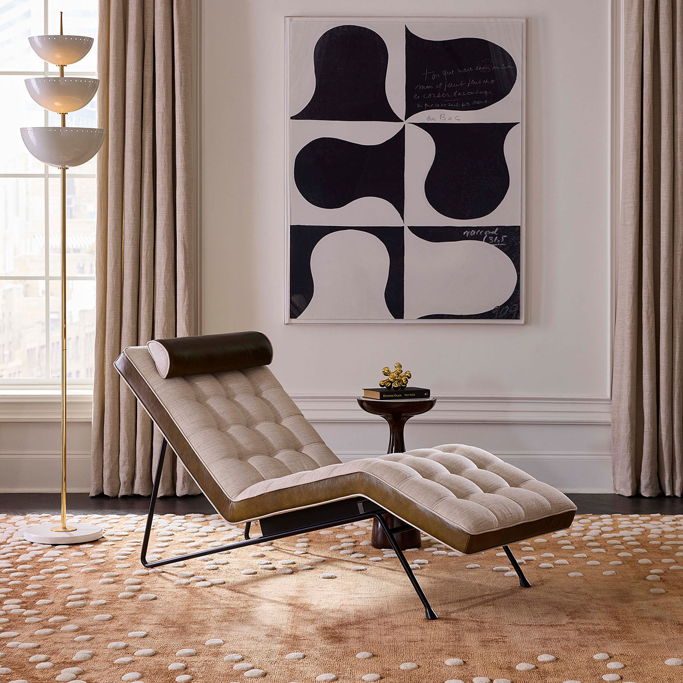 Modern lounge chair in a stylish living room with abstract art on the wall.
