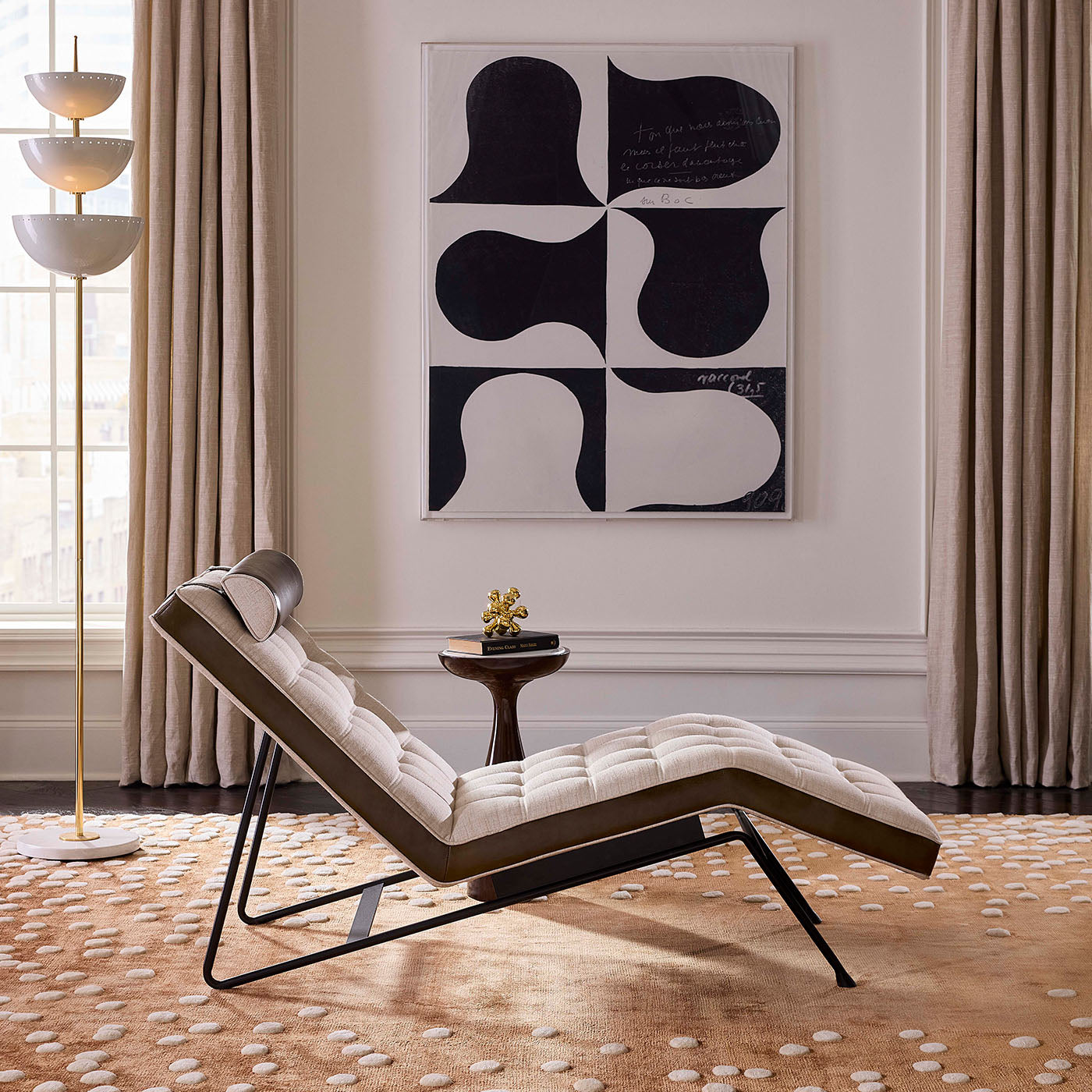 Modern lounge chair in a stylish living room with abstract art and decor.