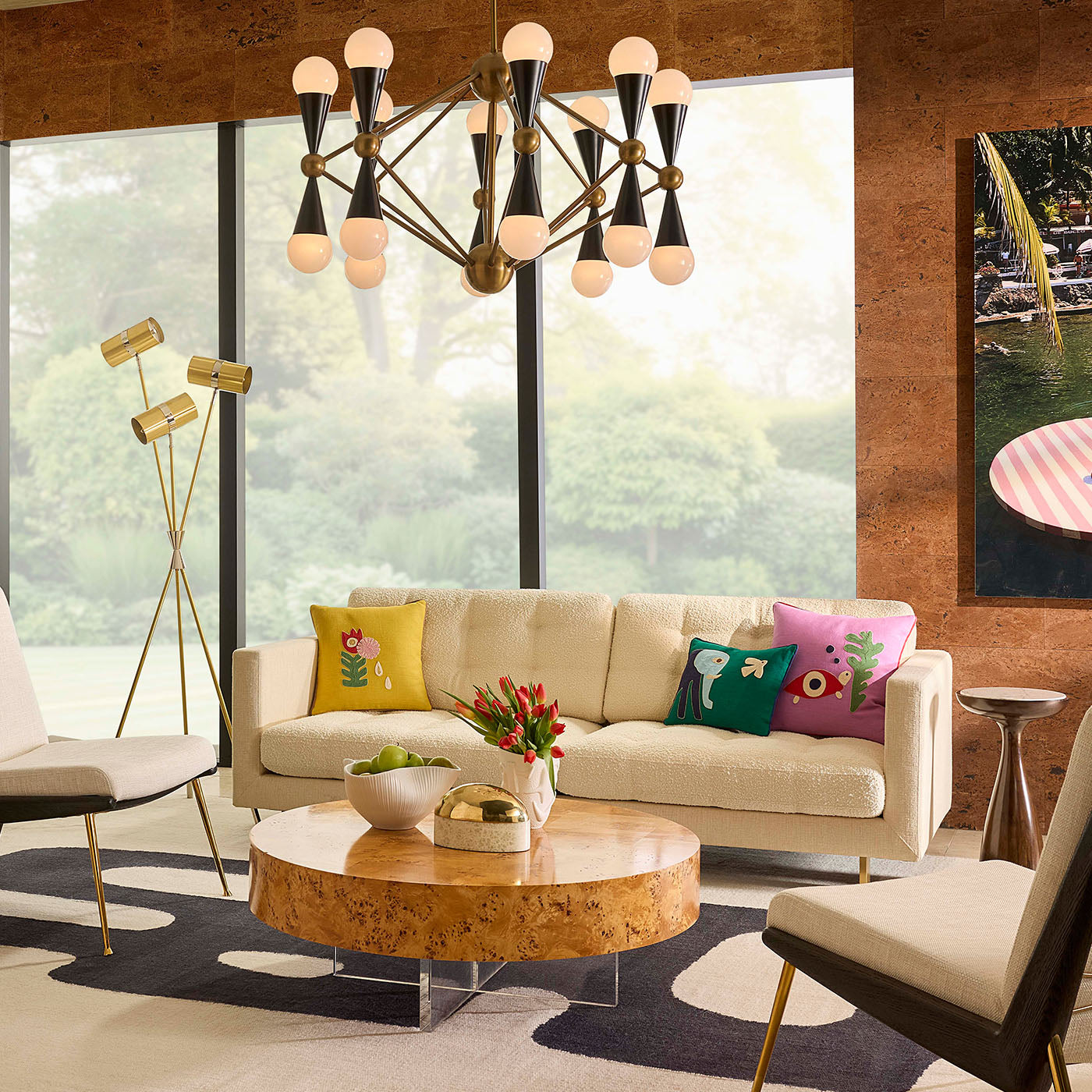 Modern living room with a chandelier, sofa, and decorative items.