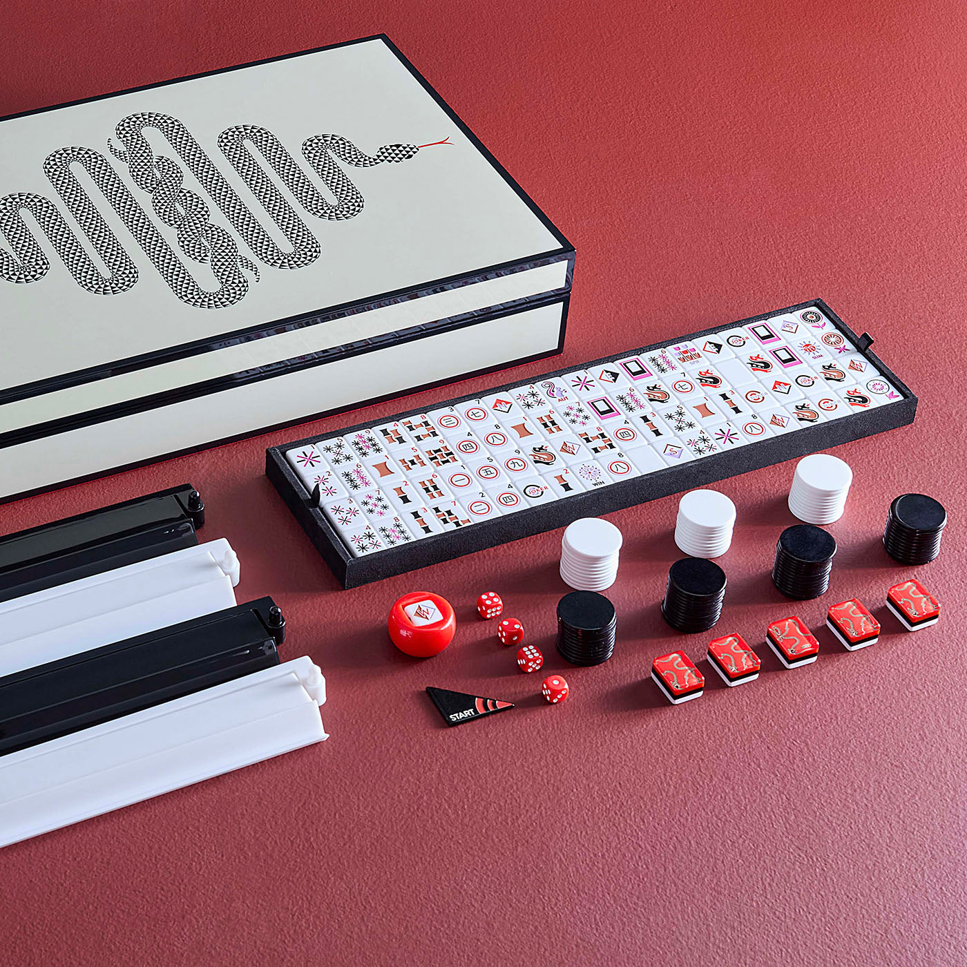 Mandarin duck mahjong set with tiles, dice, and carrying case on a red surface