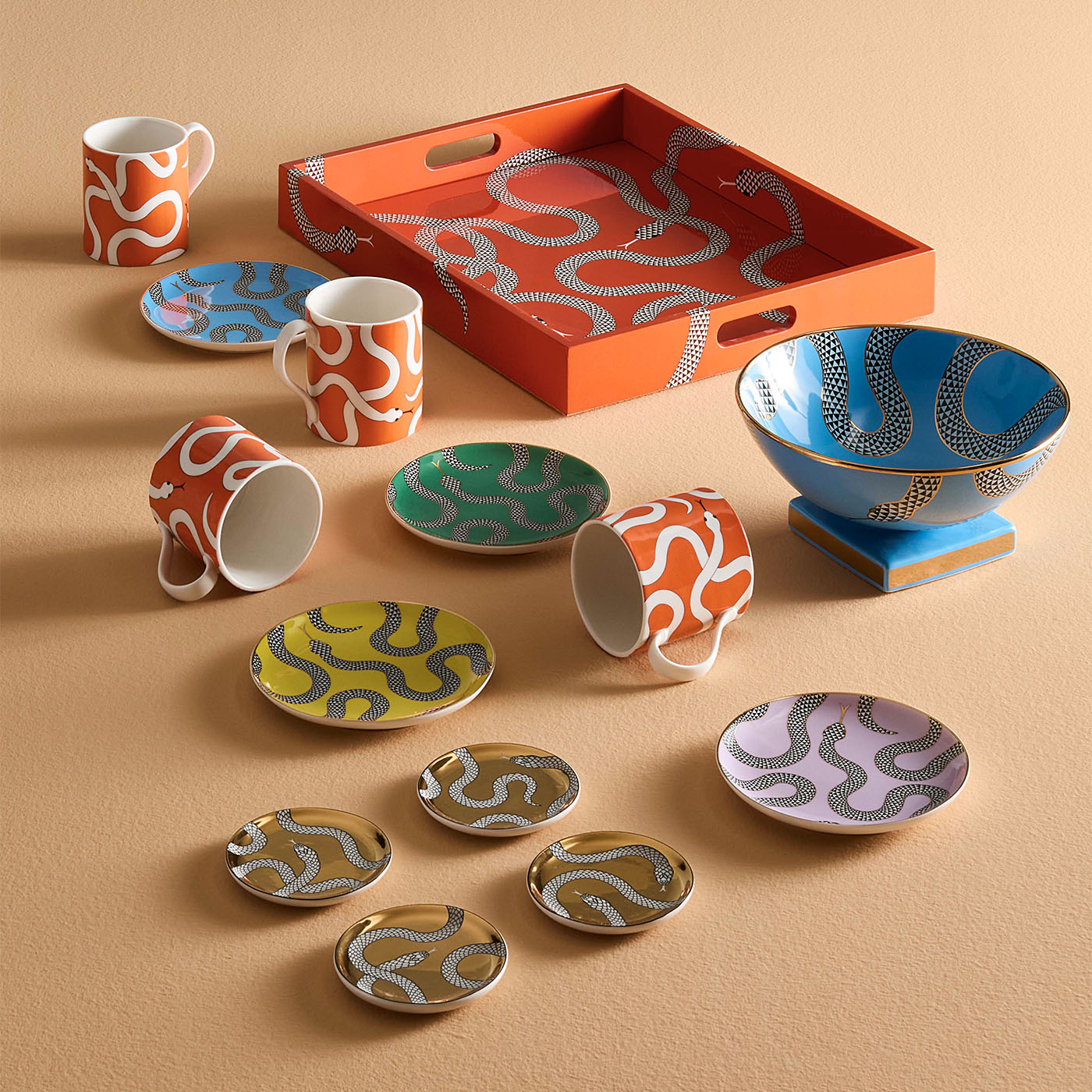 Colorful ceramic tableware set on a beige surface
