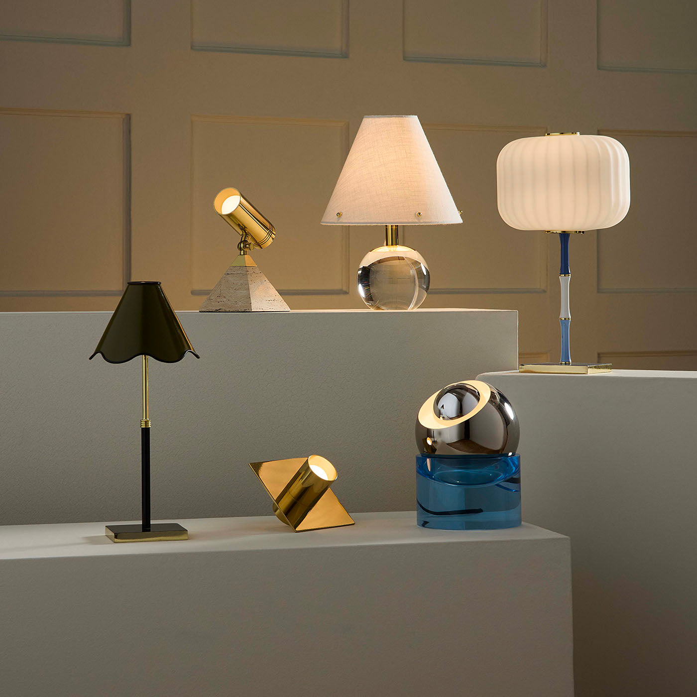 Collection of various table lamps on a gray surface with a neutral background