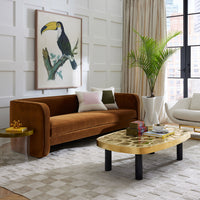 Modern living room with brown sofa, wooden coffee table, and decorative elements.