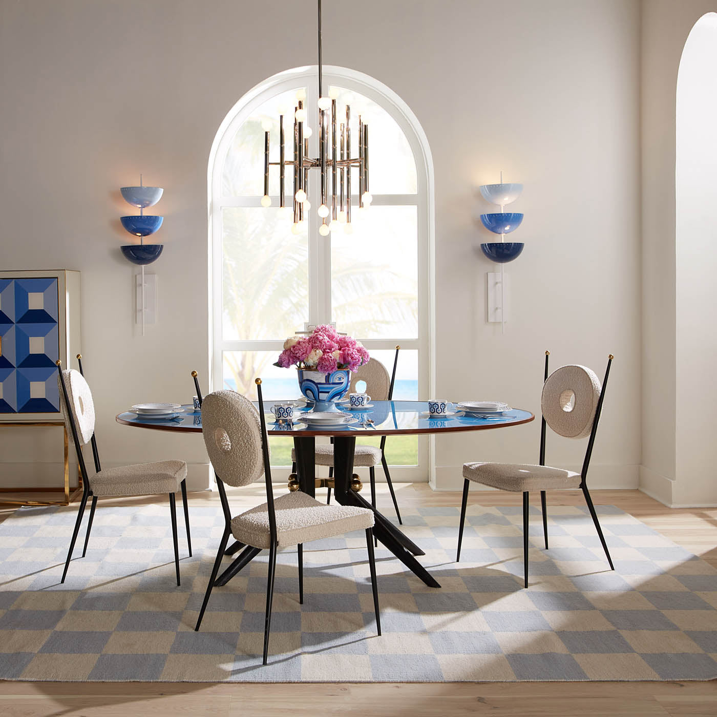 large scale checkerboard flat weave rug with goldfinger chair