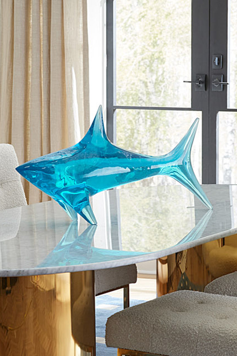  Blue clear shark sculpture on table 
