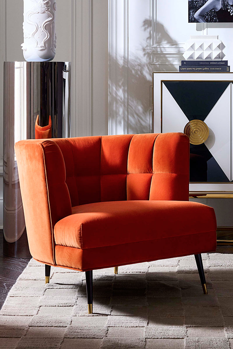 Orange velvet accent chair with black and brass legs 