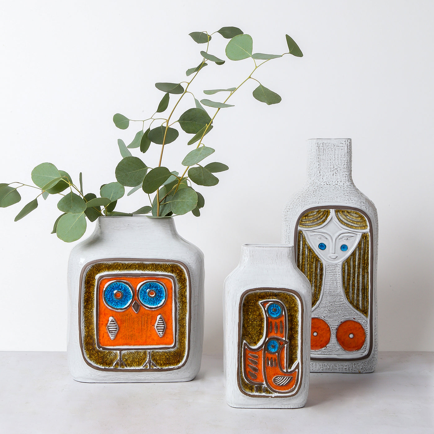 glass menagerie vase collection with eucalyptus - styled view