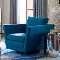 A modern blue upholstered accent chair with a swivel base, shown in a styled interior setting next to a reflective silver side table.