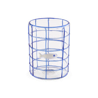 Clear glass vase with blue grid pattern and white fish charm on a white background