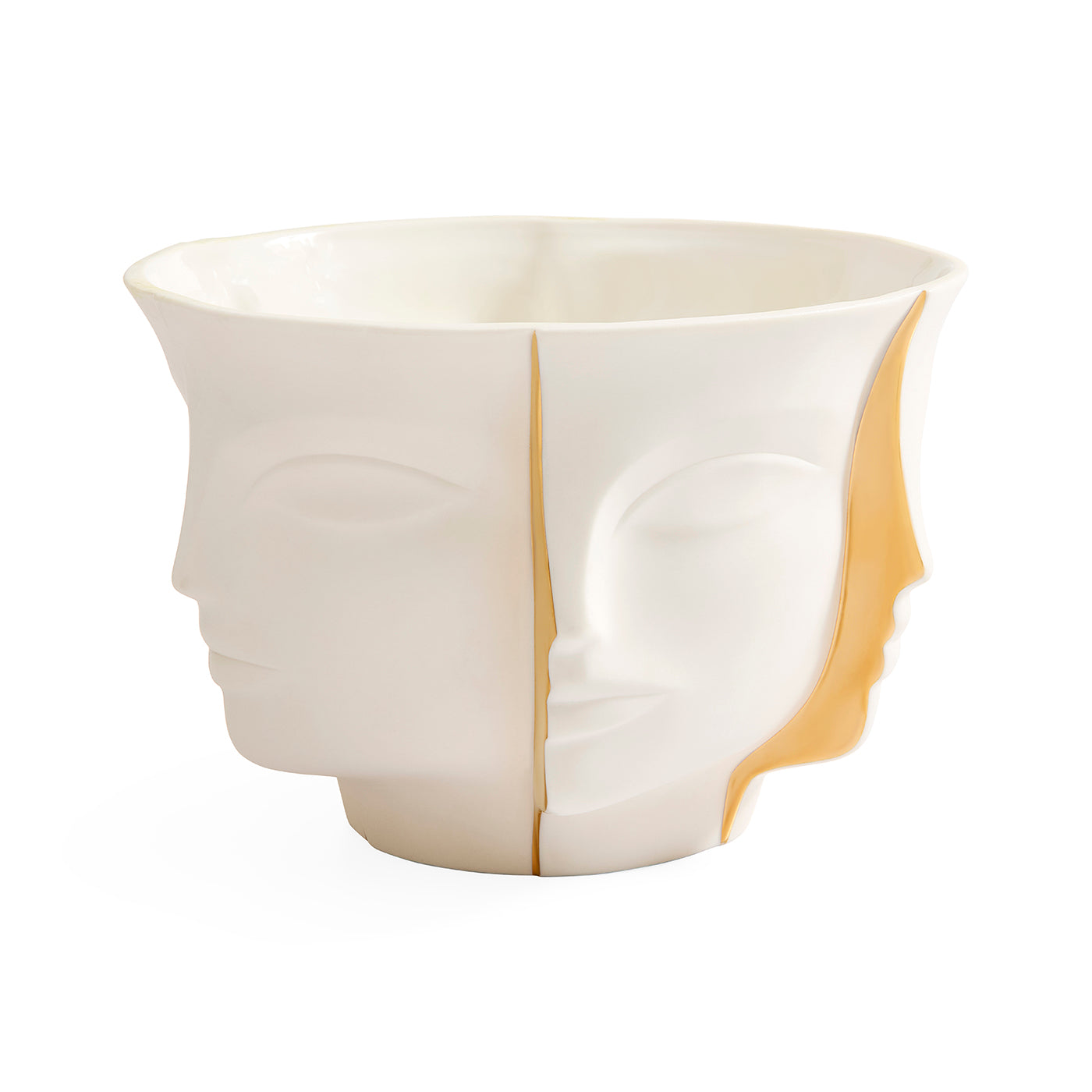 A sculptural ceramic bowl featuring a split-face design with one half showing a profile of a face in profile and the other half showing a profile of a face facing forward, in glossy off-white with a warm gold interior accent.