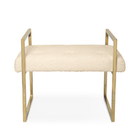 Beige cushioned bench with gold metal frame on a white background