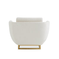A modern armchair upholstered in textured off-white bouclé fabric with a gold metal base, shown from the back against a solid white background.