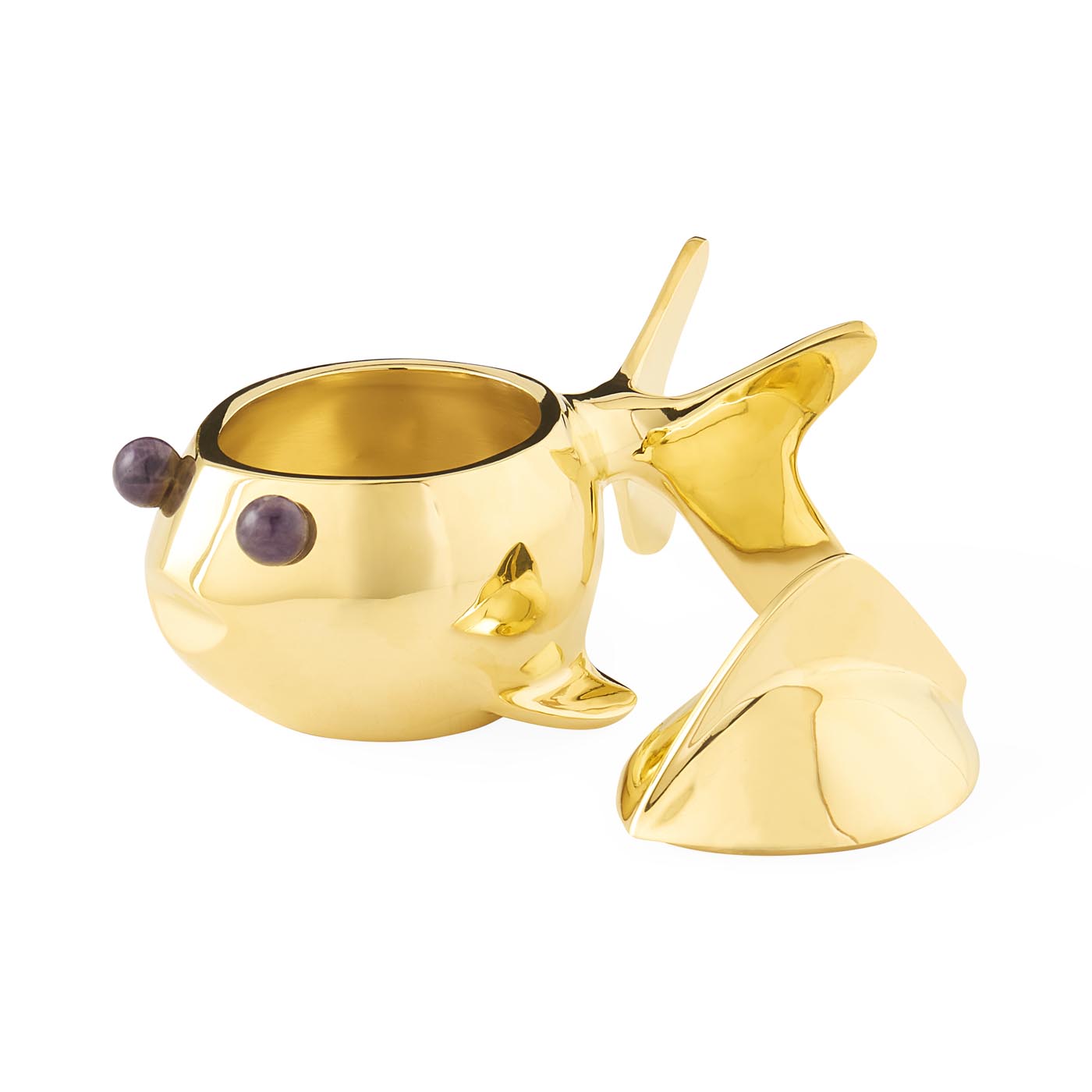 Gold whale-shaped candle holder on a white background